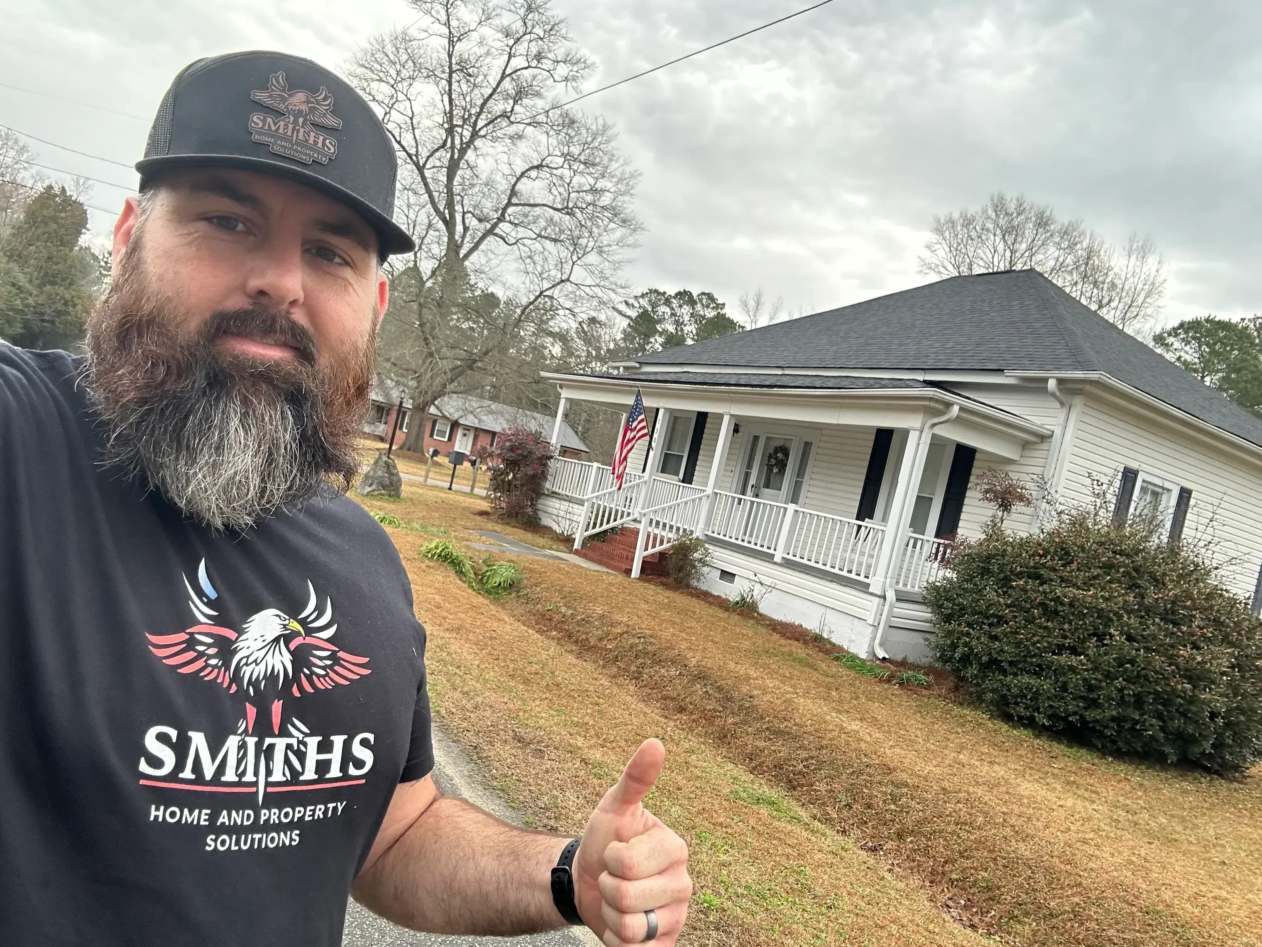 Roof cleaning removing moss and algae from asphalt shingle roof on residential home