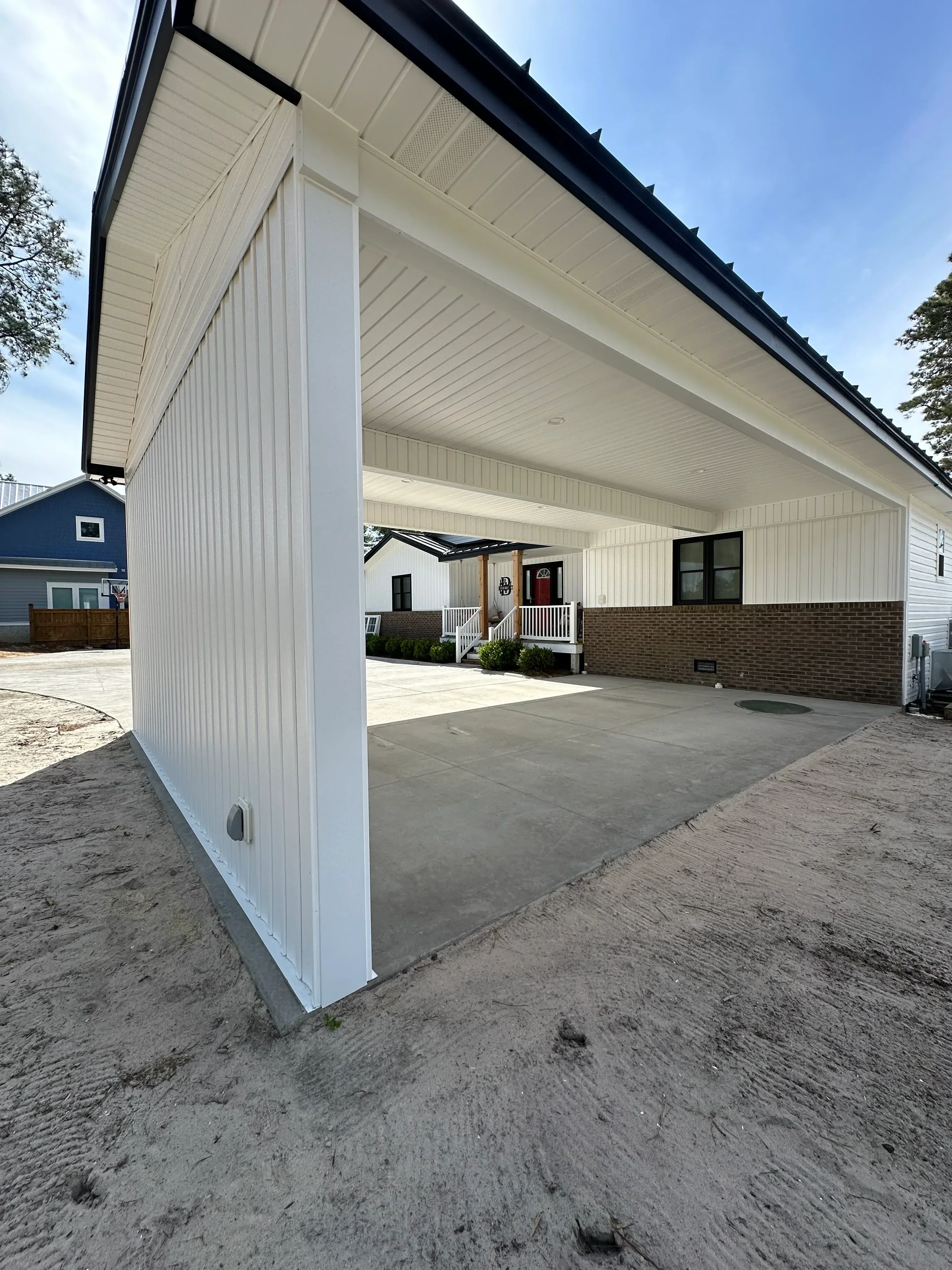 White vinyl siding and soffit installation on residential home exterior